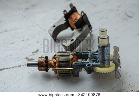 Disassembled Motor For Used Kitchen Mixer. Stator And Rotor On A Light Table. Service And Repair Of 
