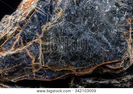 Biotite (black Mica) Mineral On Black Background.