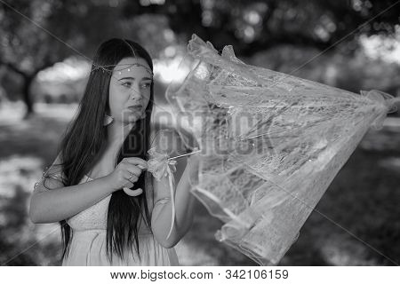 Portrait Of Young Woman With Headband And Umbrella.