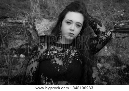 Portrait Of Young Woman With Black Clothes.