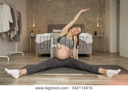 Pregnant Woman Working Out At Home During The Third Trimester Practising Healthy And Active Lifestyl