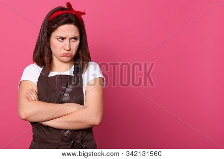 Stuio Shot Of Sad European Housewife Posing Isolated Over Pink Background In Studio, Looking Away, H