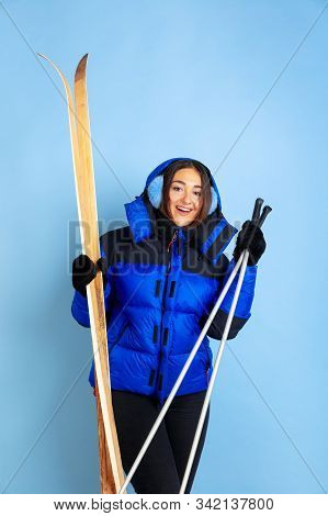Skii Lover. Caucasian Womans Portrait On Blue Studio Background. Beautiful Female Model In Warm Clot