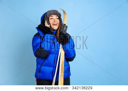 Skii Lover. Caucasian Womans Portrait On Blue Studio Background. Beautiful Female Model In Warm Clot