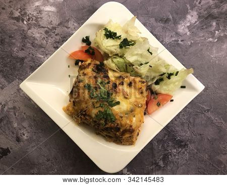 Lasagna Al Forno With Sauce Bolognese And Salad.