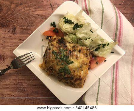 Lasagna Al Forno With Sauce Bolognese And Salad.
