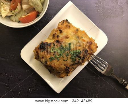 Lasagna Al Forno With Sauce Bolognese And Salad.