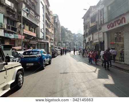 Mumbai, India - December, 2019: Cityscape Of Mumbai With Old Buildings And Empty Street And People W