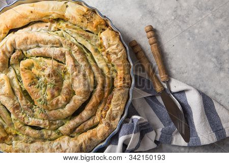 Spanakopita. Greek Pie Spanakopita  Over Concrete  Background. Ideas And Recipes For Vegetarian Or V