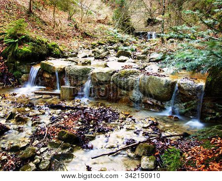 Small Waterfall From A Creek In A Forest In The Alps