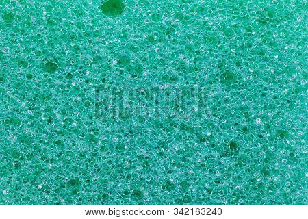 Green Kitchen Cleaning Sponge Texture. Close Up Cleaner Spunge Porous Surface