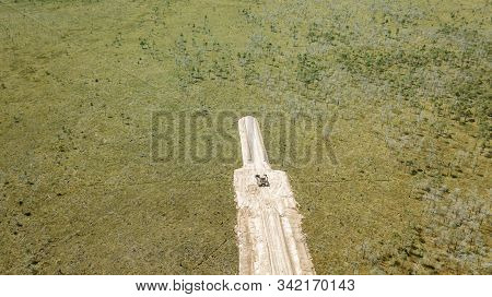 The Excavator Works On The Consruction Of The Road Through The Swamp Olmany. Ecological Problem.