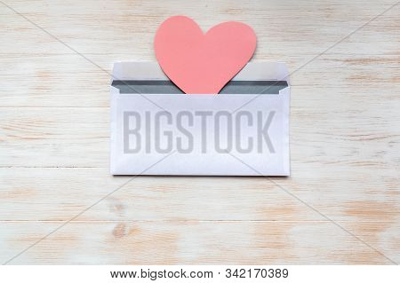 Open White Envelope With Pink Paper Heart For Valentine Day On Vintage White Painted Wooden Backgrou