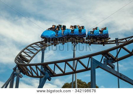 Canela, Brazil - July 21, 2019. People In A Blue Cart Having Fun On Roller Coaster In A Cloudy Day A
