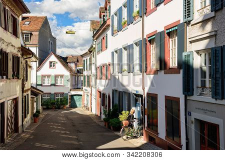Basel, Switzerland - April 17, 2019. Picturesque Historical Neighborhood In The Spring. Woman On A B