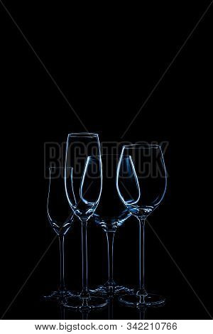 Glassware Selection With Wine, Champagne And Liquour Glasses Toned In Classic Blue On The Dark Backg