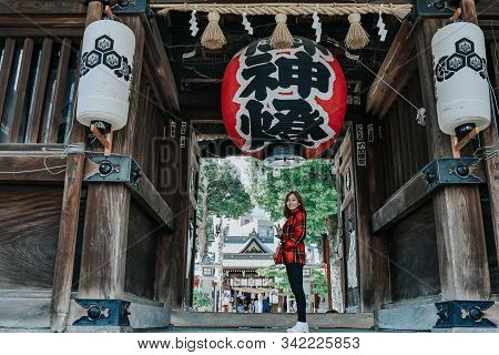 Kushida Shrine, Hakata, Fukuoka, Japan - November 2019 : Girl In Red Suit In Front Of Kushida Shrine