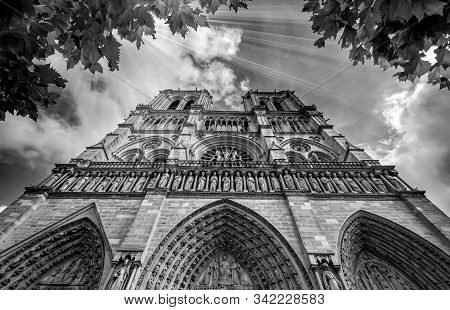 Notre Dame In Paris France. Notre Dame Cathedral With Golden Light Rays And Beautiful Gothic Archite