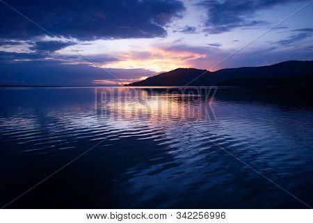 Orange Sunset On Beautiful Purple Blue Sky Along Lake Itza With Dramatic Waves, El Remate, Peten, Gu