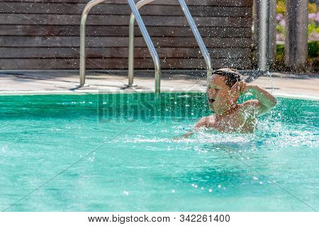 Troia, Portugal - June 2018. Boy Playing In The Swimming Pool