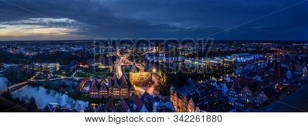 Luebeck, Germany - December 17, 2019:  Aerial Night View Panorama Of The Illuminated City Of Luebeck