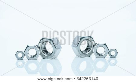 Set Of Metal Hexagon Nuts Isolated On White Background. Small, Medium, And Big Of Silver Metal Hexag
