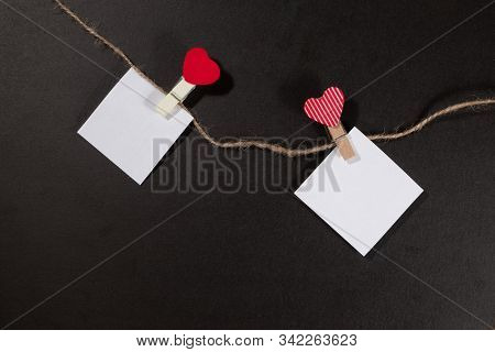 Two Paper Stickers Attached With Clothespins On A Rope And Hand Made Heart Makes. Valentines Day Bla