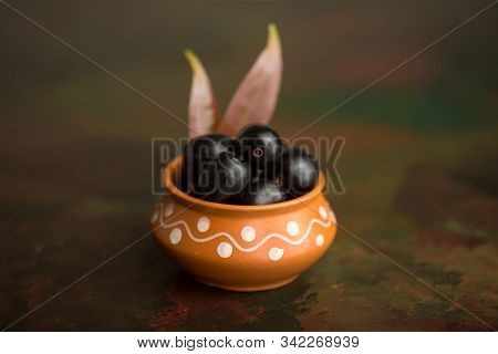 Jambolan Plum Or Jambul Or Jamun Fruit, Java Plum (syzygium Cumini) On Textured Background.