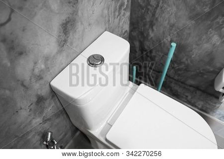 Close Up On A Flush Toilet Button For Cleaning A Toilet.