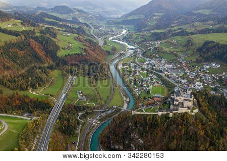 Aerial View Of Green Meadows With Villages And Forest In Austrian Alps Mountains.