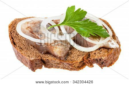 Open Sandwich With Rye Bread And Pickled Herring Decorated Of Onion Rings And Fresh Green Parsley Le