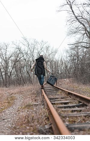 A Man On The Railway Steps On A Journey From Hustle And Bustle. Stock Photo.