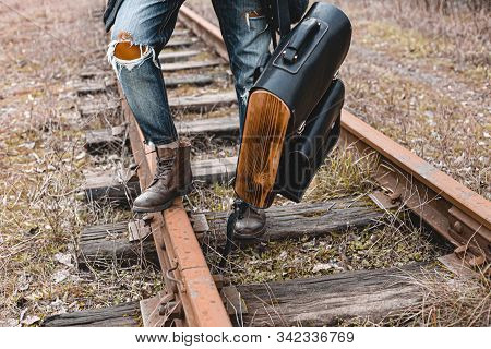 A Guy In Suede Autumn Boots On The Railway. The Concept Of Hiking, Travel Practical Clothes, Shoes.