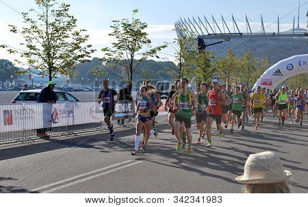 Warsaw, Poland - April 14, 2015: Orlen Warsaw Marathon. Group Of Athletes Running On A Street.