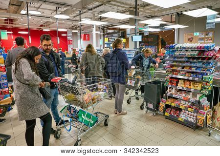 BERLIN, GERMANY - CIRCA SEPTEMBER, 2019: people in line at Kaufland in Berlin. Kaufland is a German hypermarket chain, part of the Schwarz Gruppe which also owns Lidl and Handelshof.