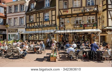 Colmar, France - April 18, 2019. Overcrowded Restaurant In The Old Half-timbered House, Decorated Wi