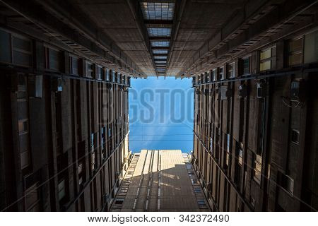 Sunlight And Blue Sky Seen From A Square Inner Courtyard Of A High Rise Communist Housing Building I