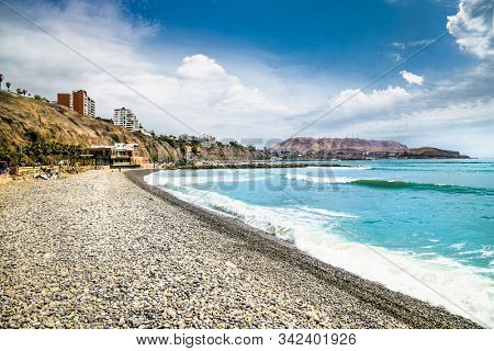 Pacific coast view in sunny day, observation deck, stairway to the beach. View from the Public park in Miraflores district. Lima, Peru. 