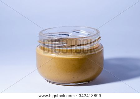 A Yellow Mustard Bottle Against A White Background With Clipping Path