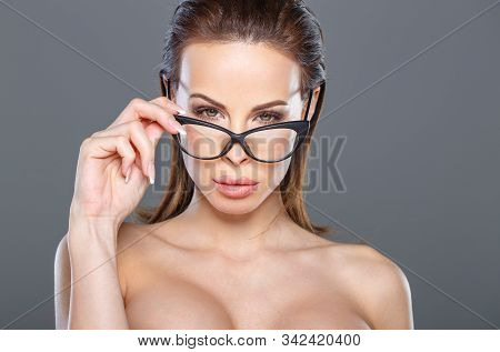 Sexy Young Tempting Brunette Woman Looking While Taking Off Eyeglasses