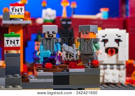 Kiev, Ukraine - December 29, 2019: Minifigure Steve And Alex With Diamond And Iron Swords Run Away F