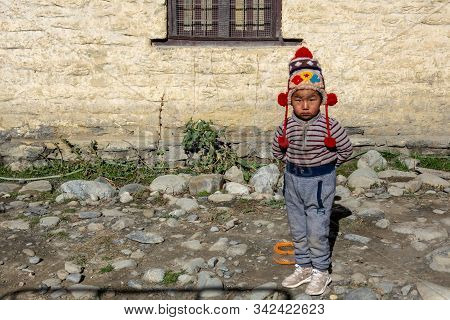 Young Nepali Boy Standing Beside Road