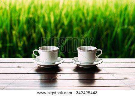 White Tea Cups On A Beautiful Background. White Coffee Cups Against The Background Of Rice Terraces 