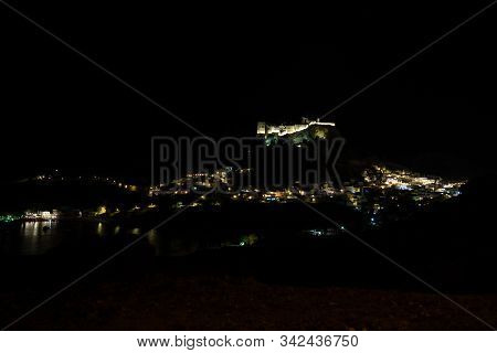 View At The Illuminated City Of Lindos And The Acropolis On Greek Island Rhodes By Night