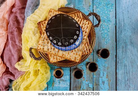 Passover Matzoh Jewish Holiday Bread With Kipah And Four Cup Of Wine Over Wooden Table Background.