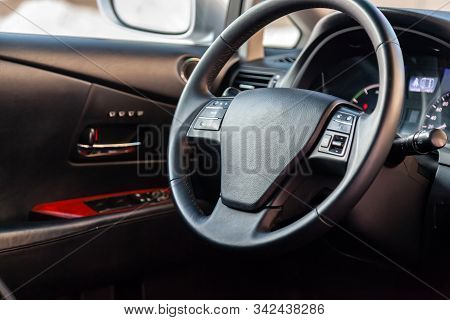 Interior View With Steeering Wheel And Dashboard Of Luxury Very Expensive New White Car Stands In Th