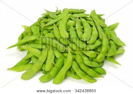 Pile Of Edamame On White Surface. Green Soybeans In The Pod. Unripe Soya Beans, Maodou. Glycine Max.