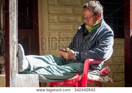 Man Playing On Mobile Phone