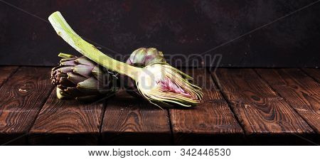 Artichokes On Rustic Background. Fresh Organic Raw Artichoke Flower