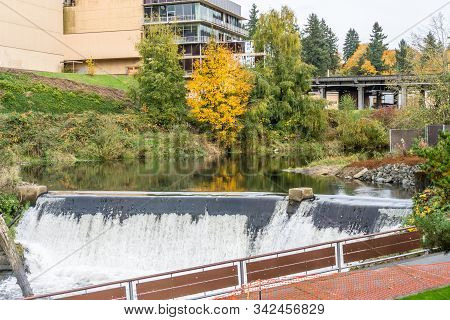 A Building Stands Abobe The Top Of Tumwater Falls In Tumwater, Washington.
